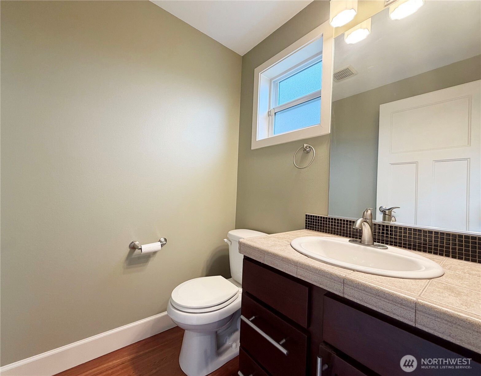 2118 West Ruffner Street Seattle, WA 98199 - Photo 12 of 37 a bathroom with a granite countertop toilet a sink and mirror