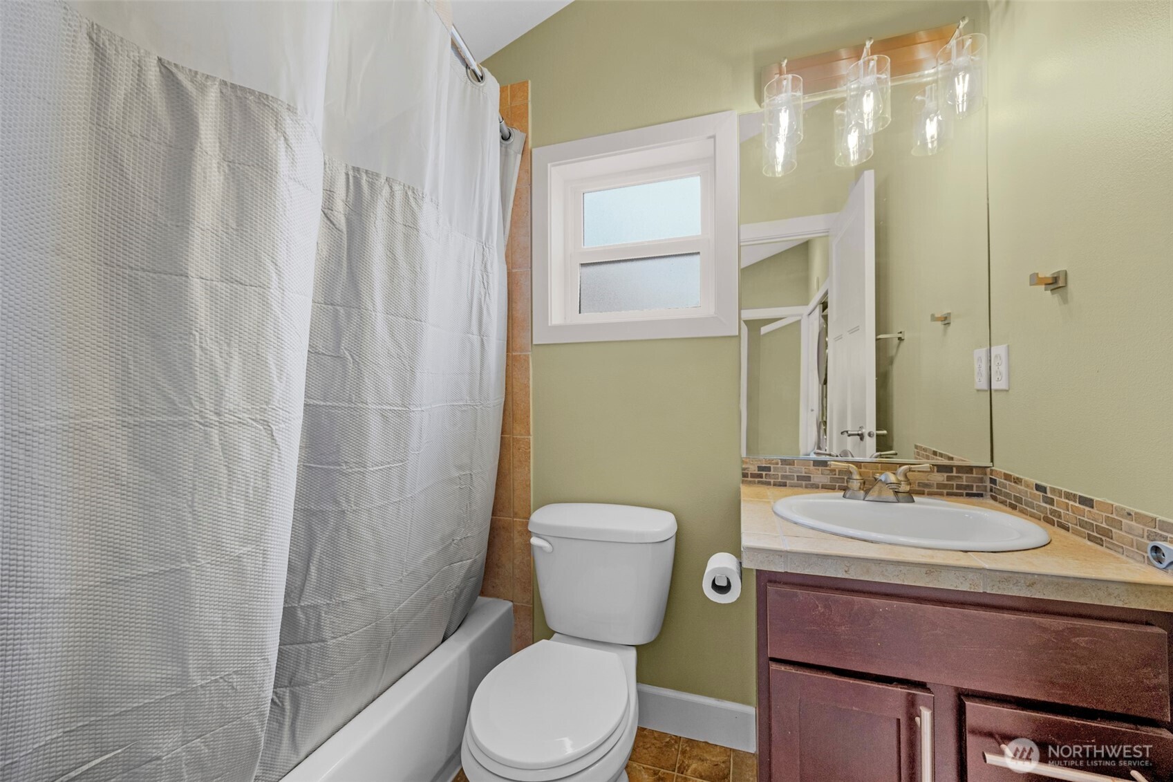 2118 West Ruffner Street Seattle, WA 98199 - Photo 19 of 37 a bathroom with a toilet a sink and a mirror