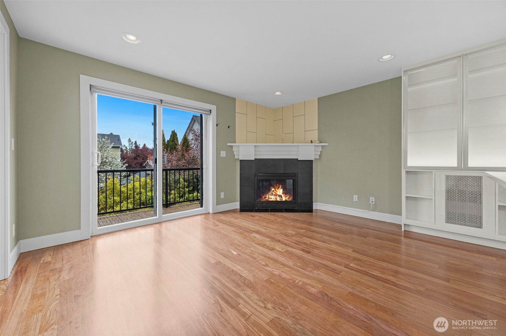 2118 West Ruffner Street Seattle, WA 98199 - Photo 3 of 37 a view of an empty room with wooden floor fireplace and a window