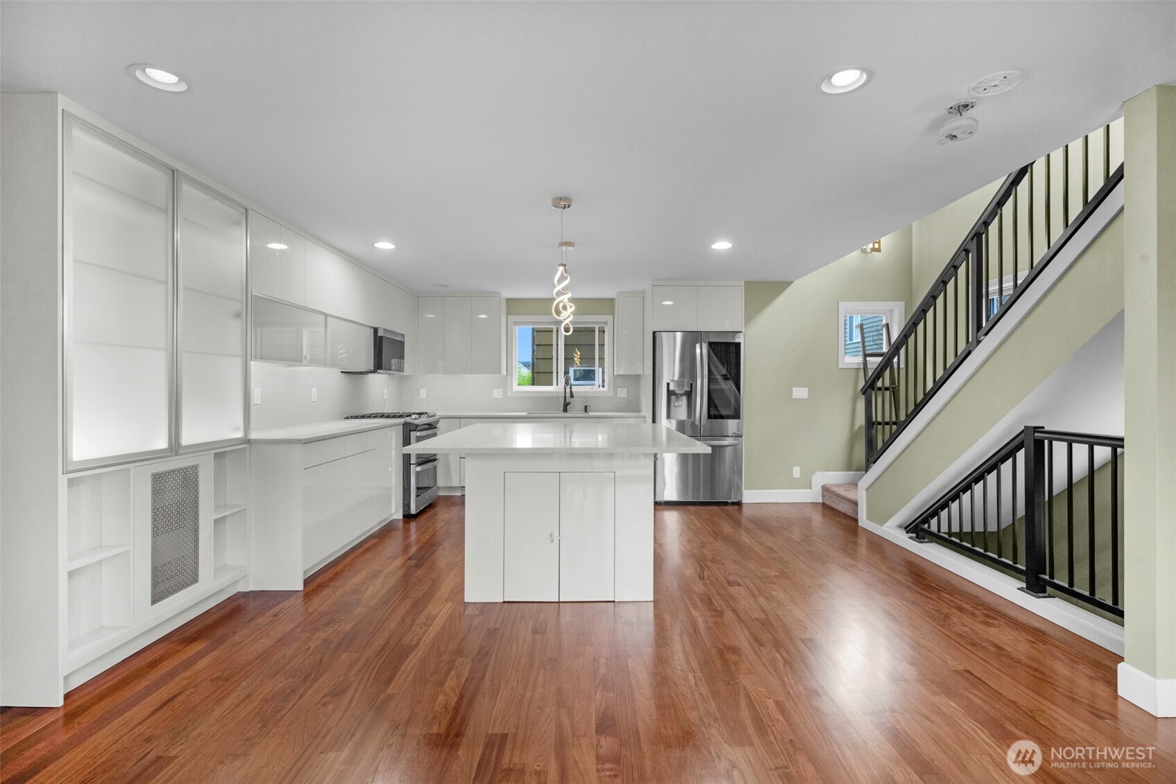2118 West Ruffner Street Seattle, WA 98199 - Photo 6 of 37 a kitchen with white cabinets and stainless steel appliances