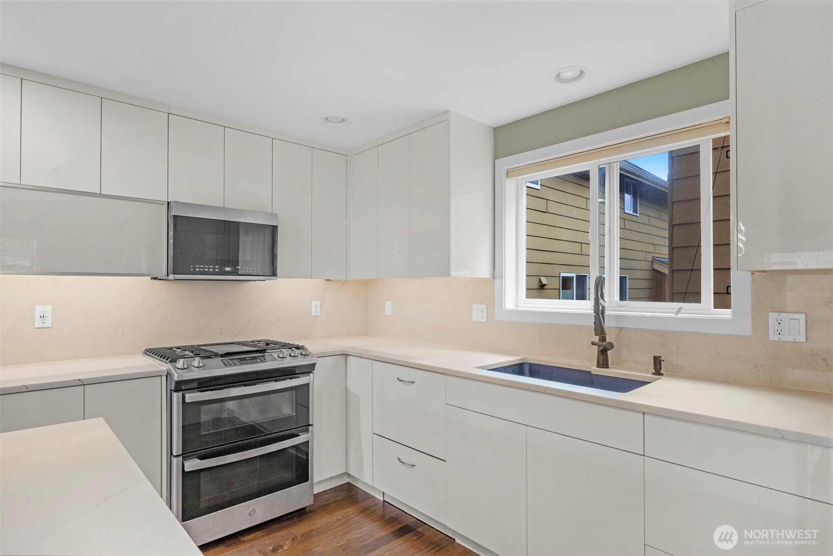 2118 West Ruffner Street Seattle, WA 98199 - Photo 9 of 37 a kitchen with a sink stove and microwave