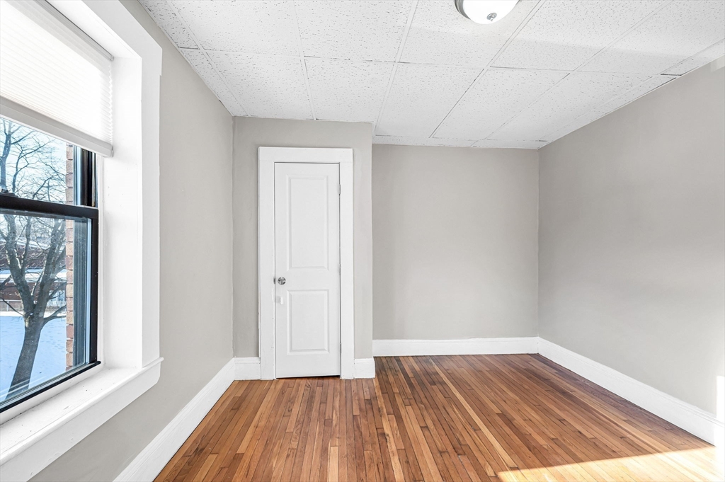 92 Woodside Terrace, Unit 3R Springfield, MA 01108 - Photo 26 of 42 a view of a room with wooden floor and doors
