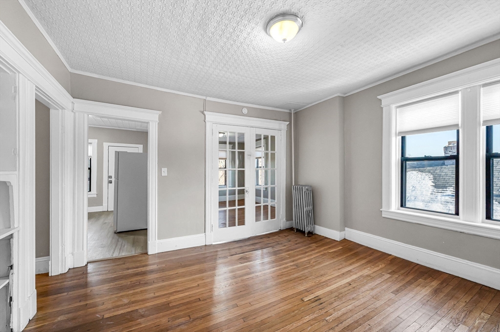 92 Woodside Terrace, Unit 3R Springfield, MA 01108 - Photo 10 of 42 wooden floor in an empty room with a window