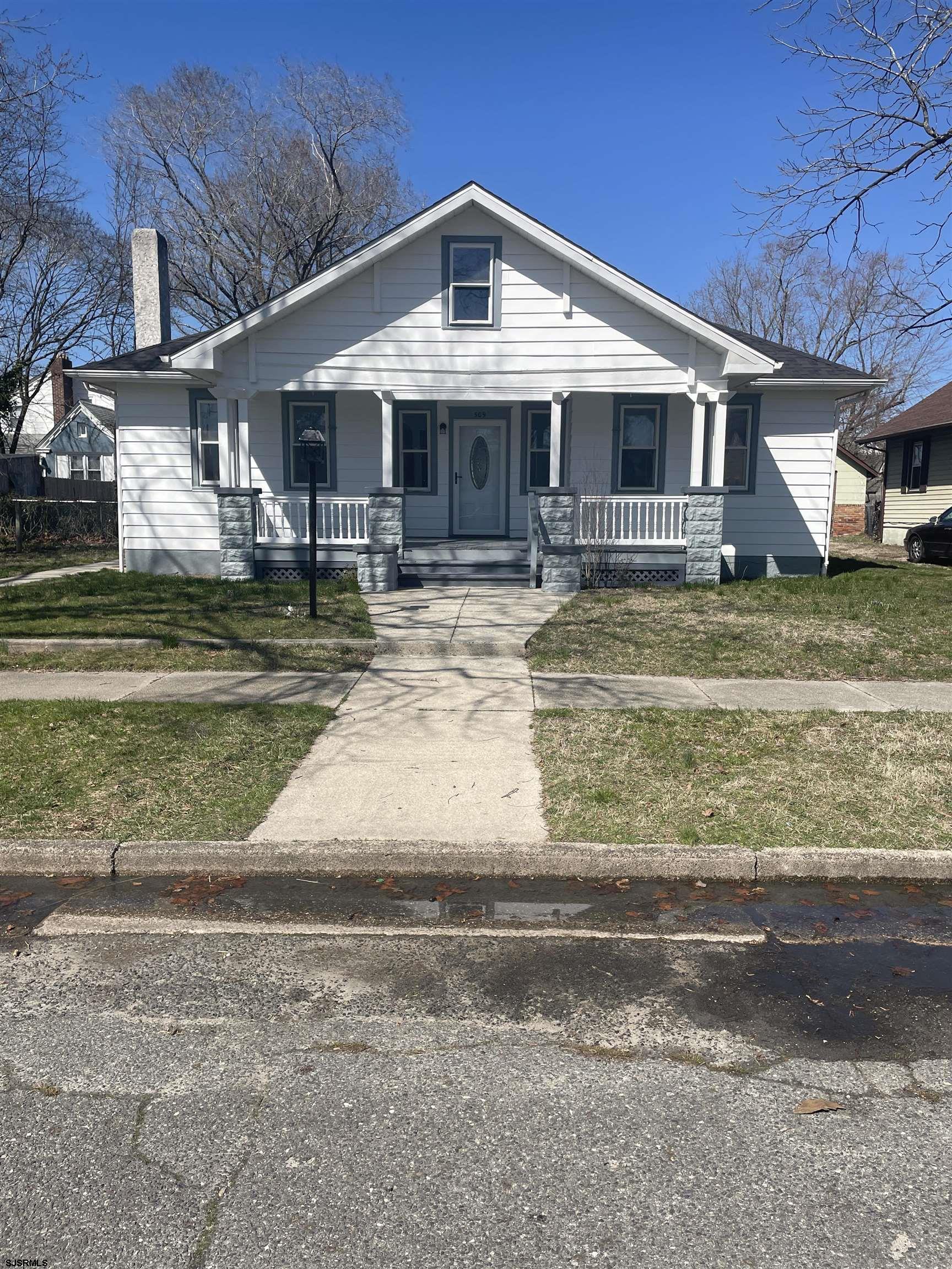 509 Buffalo Avenue Egg Harbor City, NJ 08215 - Photo 1 of 14 a front view of a house with a yard