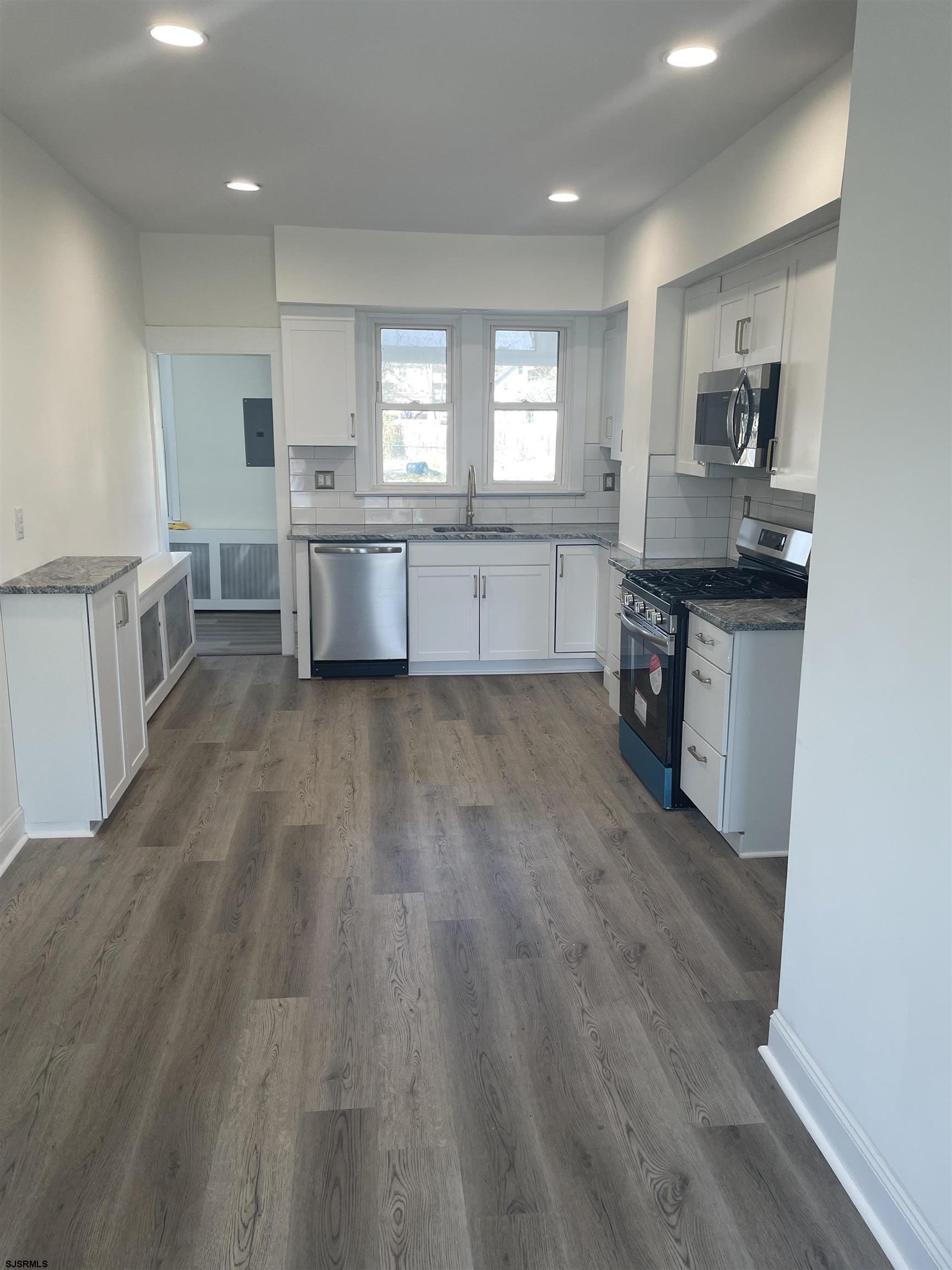 509 Buffalo Avenue Egg Harbor City, NJ 08215 - Photo 3 of 14 a kitchen with stainless steel appliances granite countertop a stove a sink and a refrigerator