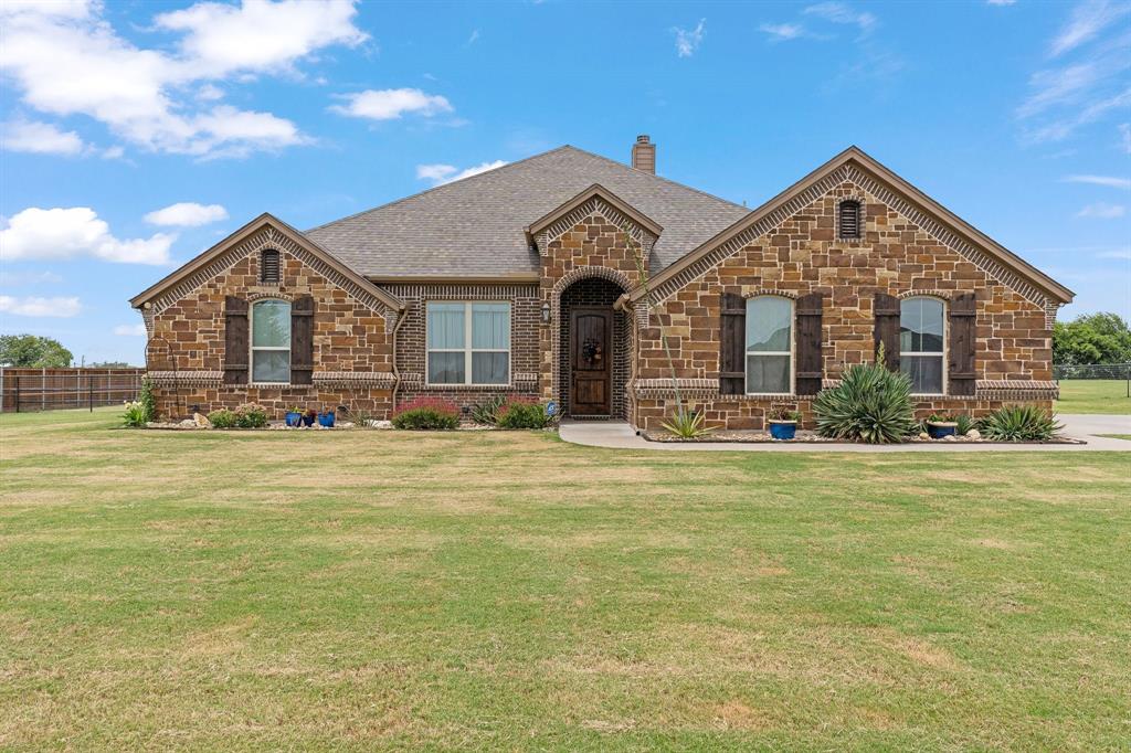 9708 Puma Trail Godley, TX 76044 - Photo 2 of 40 a front view of a house with a yard