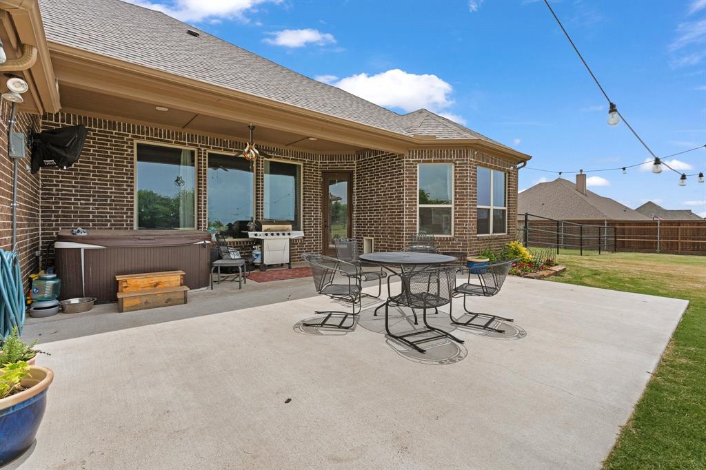 9708 Puma Trail Godley, TX 76044 - Photo 29 of 40 a view of a patio with table and chairs potted plants