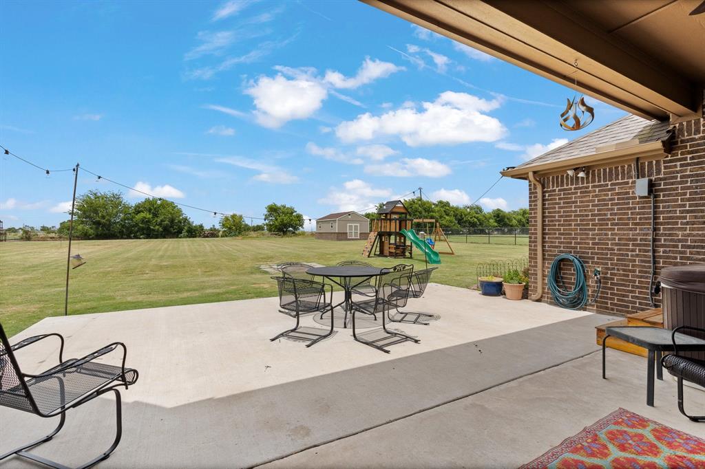 9708 Puma Trail Godley, TX 76044 - Photo 30 of 40 a view of a terrace with chairs and a table