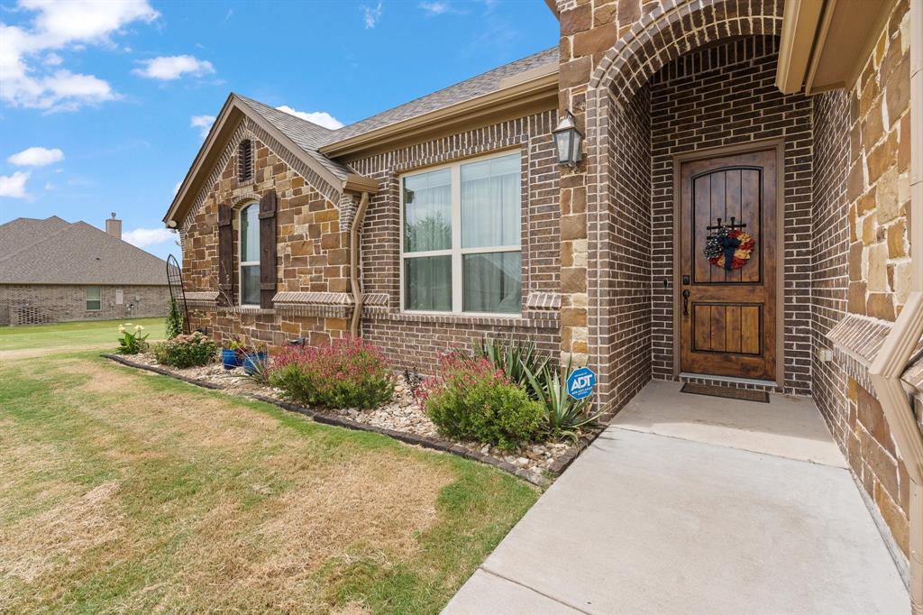 9708 Puma Trail Godley, TX 76044 - Photo 3 of 40 front view of a house with a yard