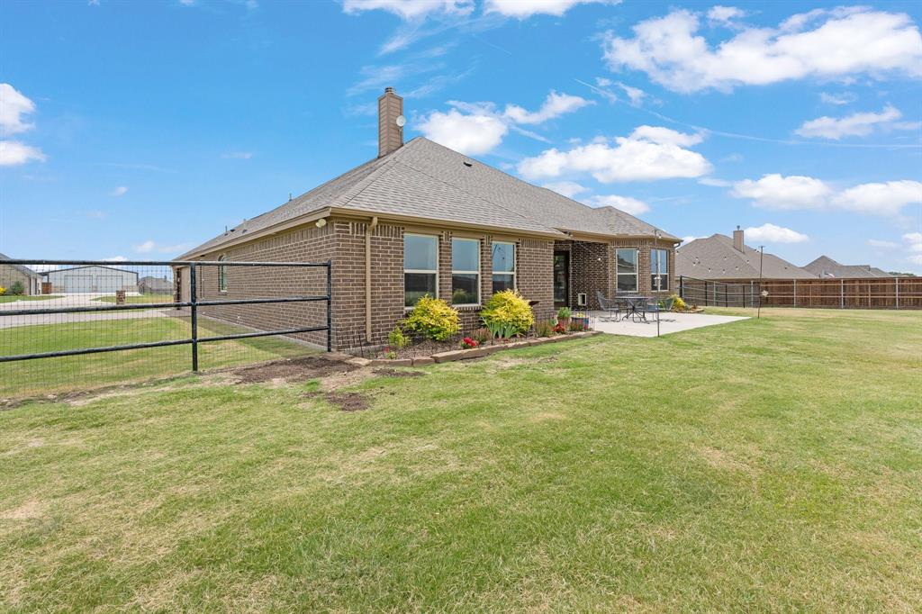 9708 Puma Trail Godley, TX 76044 - Photo 33 of 40 a front view of a house with garden