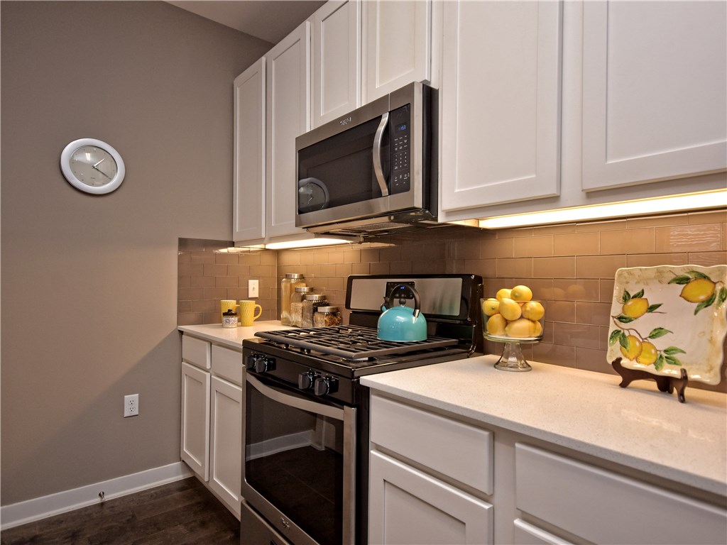 8913 Parker Ranch Circle, Unit A Austin, TX 78748 - Photo 1 of 1 a kitchen with a stove and a microwave