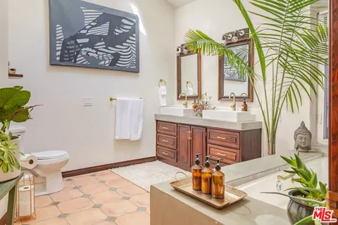 a view of a hallway with granite countertop a mirror