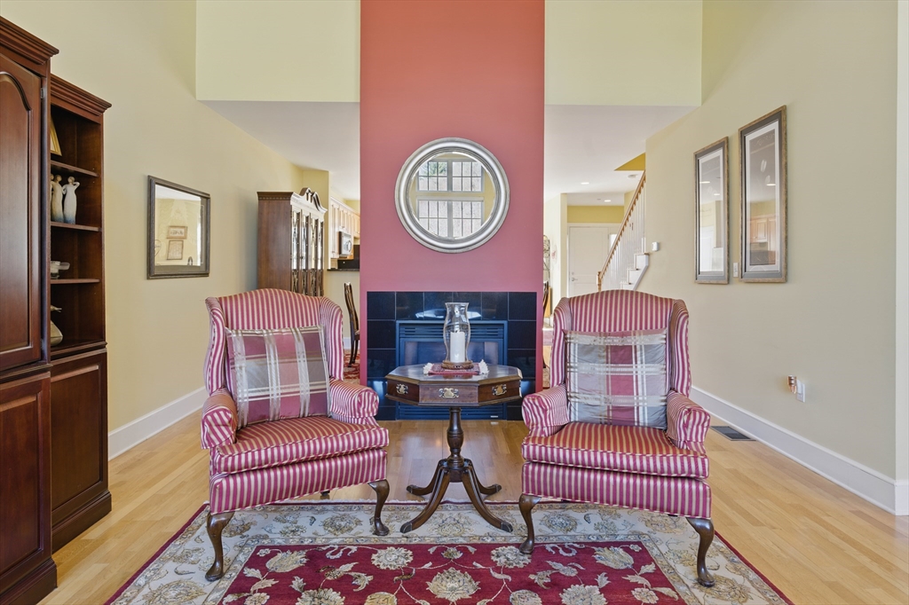 2 Powder Mill Square, Unit 2B Andover, MA 01810 - Photo 11 of 31 a living room with furniture and a clock