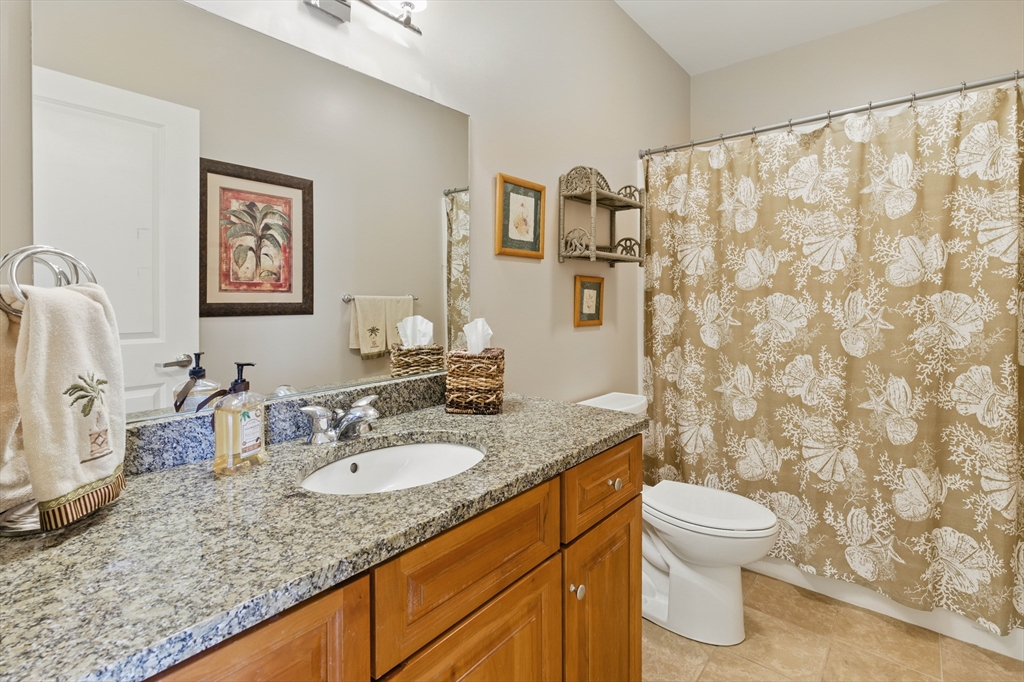 2 Powder Mill Square, Unit 2B Andover, MA 01810 - Photo 16 of 31 a bathroom with a granite countertop sink and a mirror