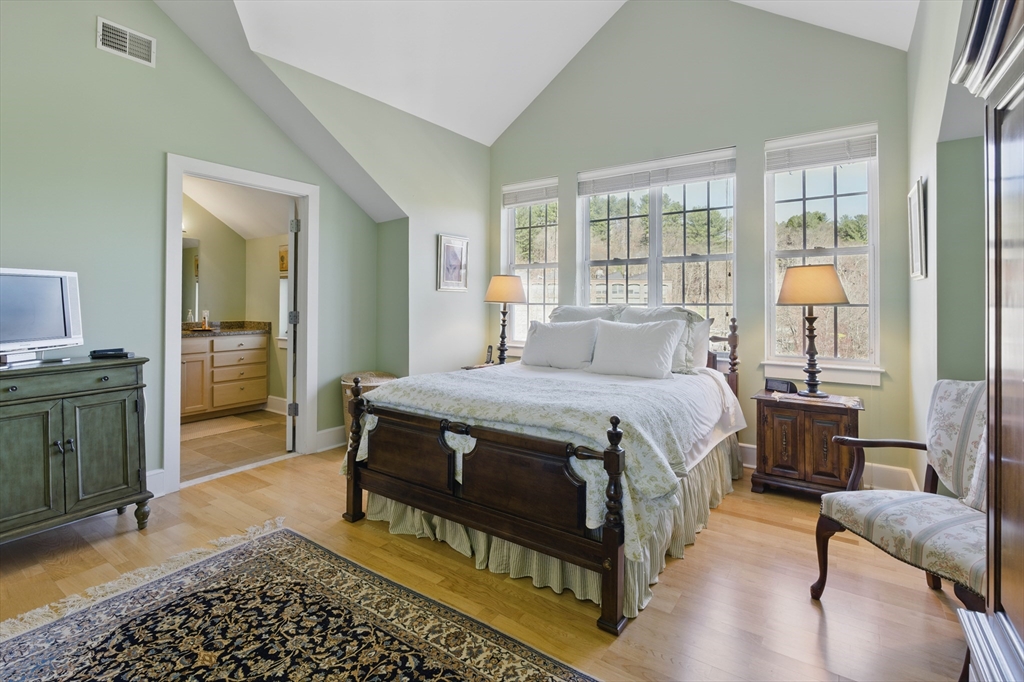 2 Powder Mill Square, Unit 2B Andover, MA 01810 - Photo 18 of 31 a bedroom with a bed and wooden floor