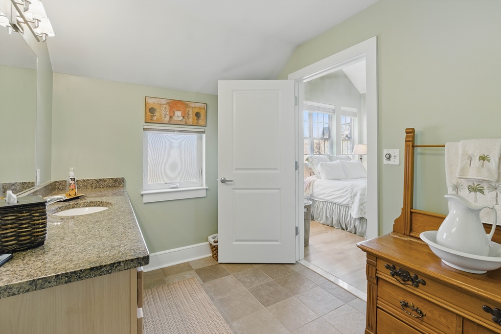 2 Powder Mill Square, Unit 2B Andover, MA 01810 - Photo 21 of 31 a bathroom with a granite countertop sink and a mirror