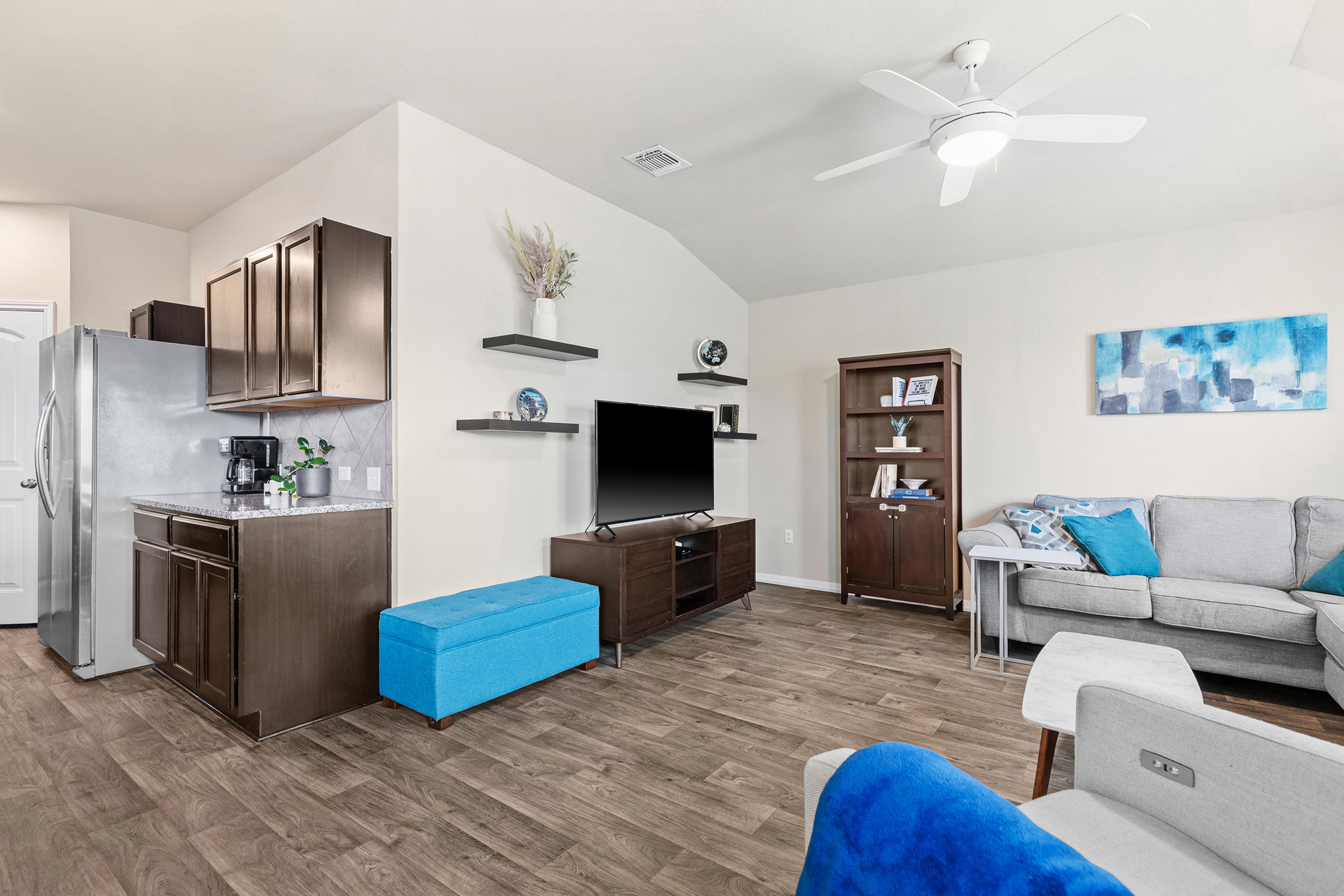 404 Cassandra Drive Hutto, TX 78634 - Photo 8 of 40 Living area featuring vaulted ceiling, dark wood-style flooring, and ceiling fan