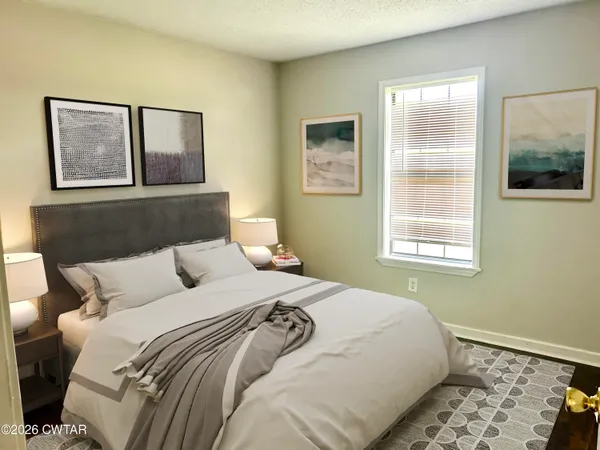 a bedroom with a bed and a window