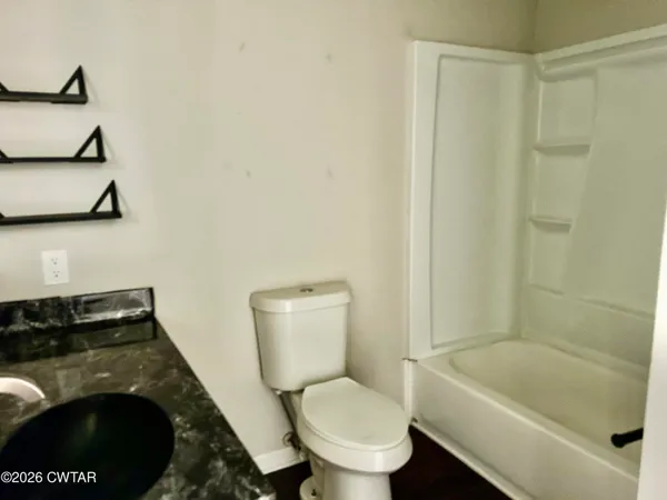 a bathroom with a toilet and a bathtub