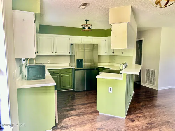 a kitchen with a sink a stove top oven and cabinets