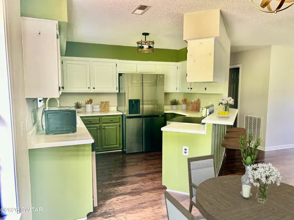 a kitchen with a sink cabinets and wooden floor