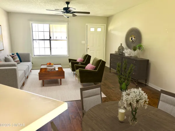 a living room with furniture and wooden floor