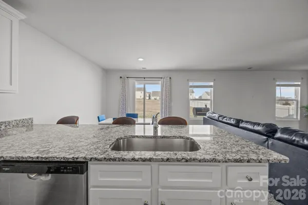 a kitchen with granite countertop a sink and a granite counter tops