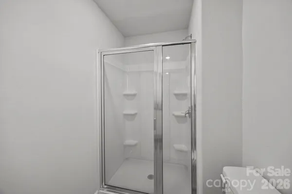 a bathroom with a glass shower door