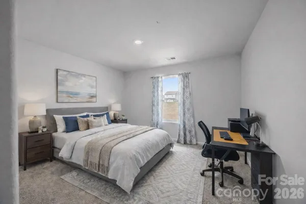 a bedroom with a bed and a desk