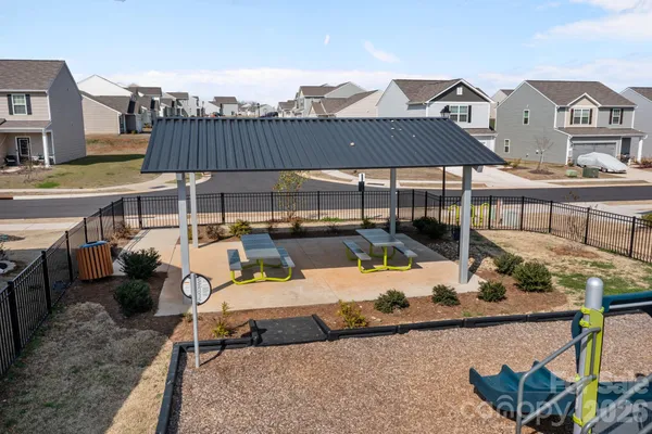 a view of a terrace with furniture and a fire pit