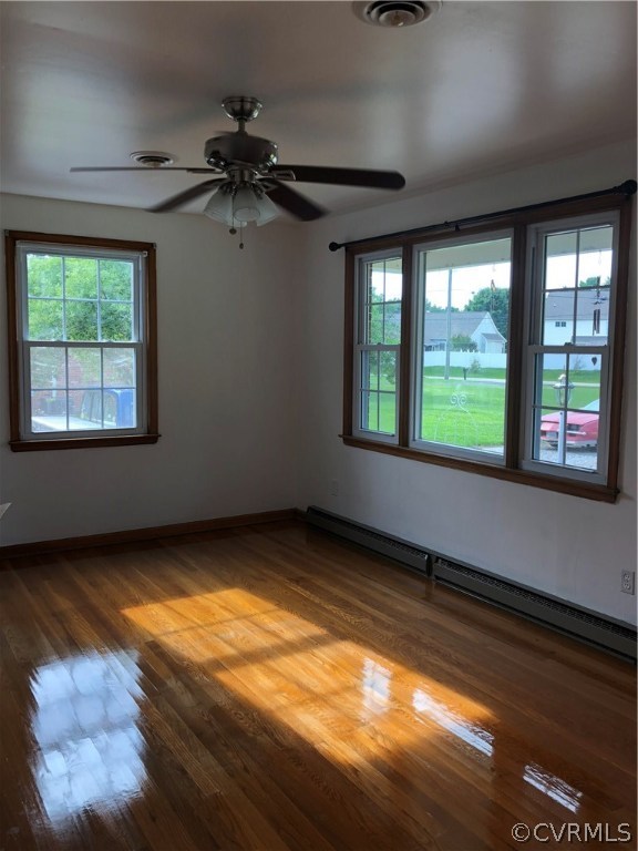 Living room with triple window and wood floor