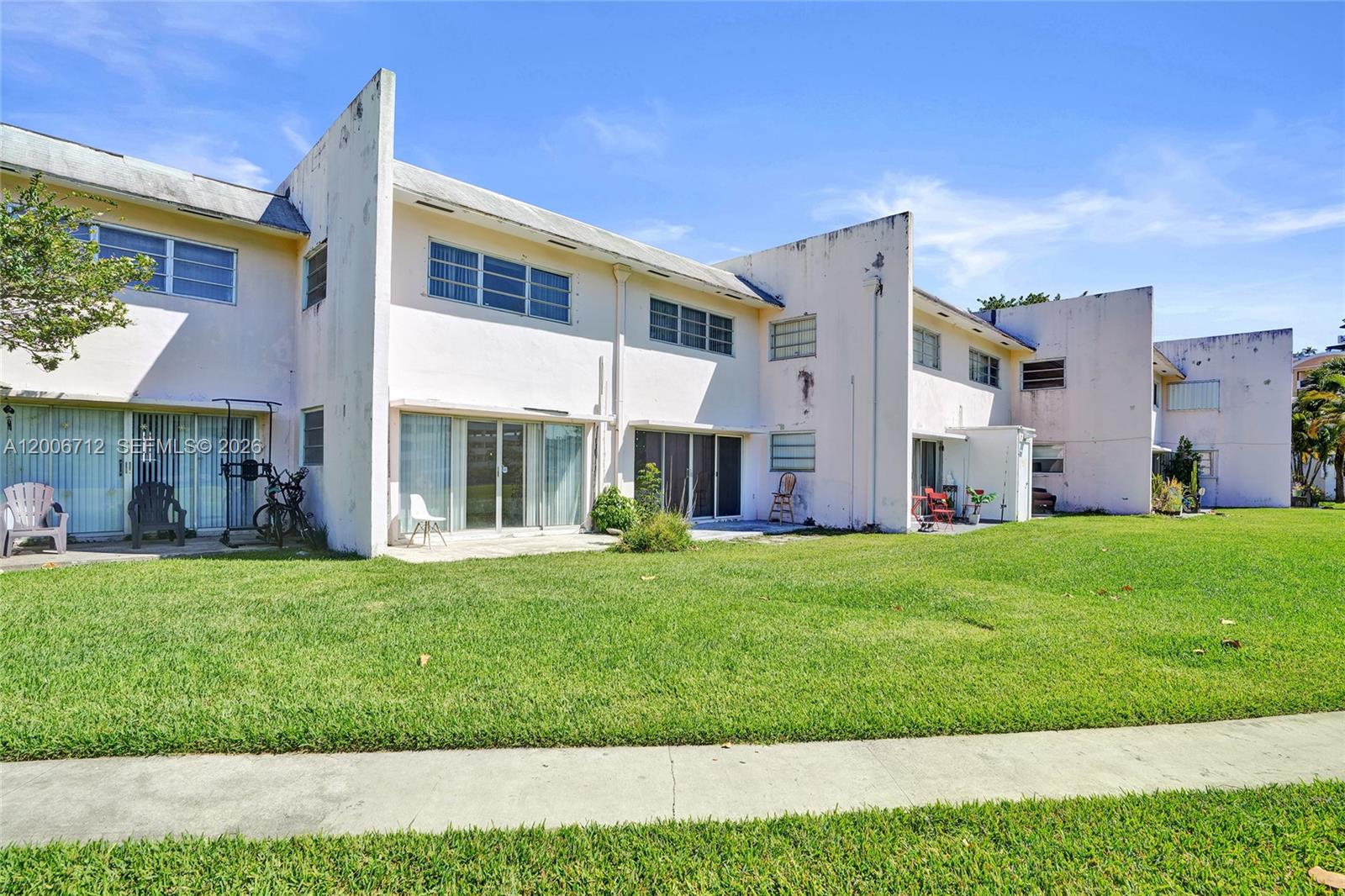 7344 Southwest 82nd Street, Unit C114 Miami, FL 33143 - Photo 1 of 30 a front view of a house with a garden