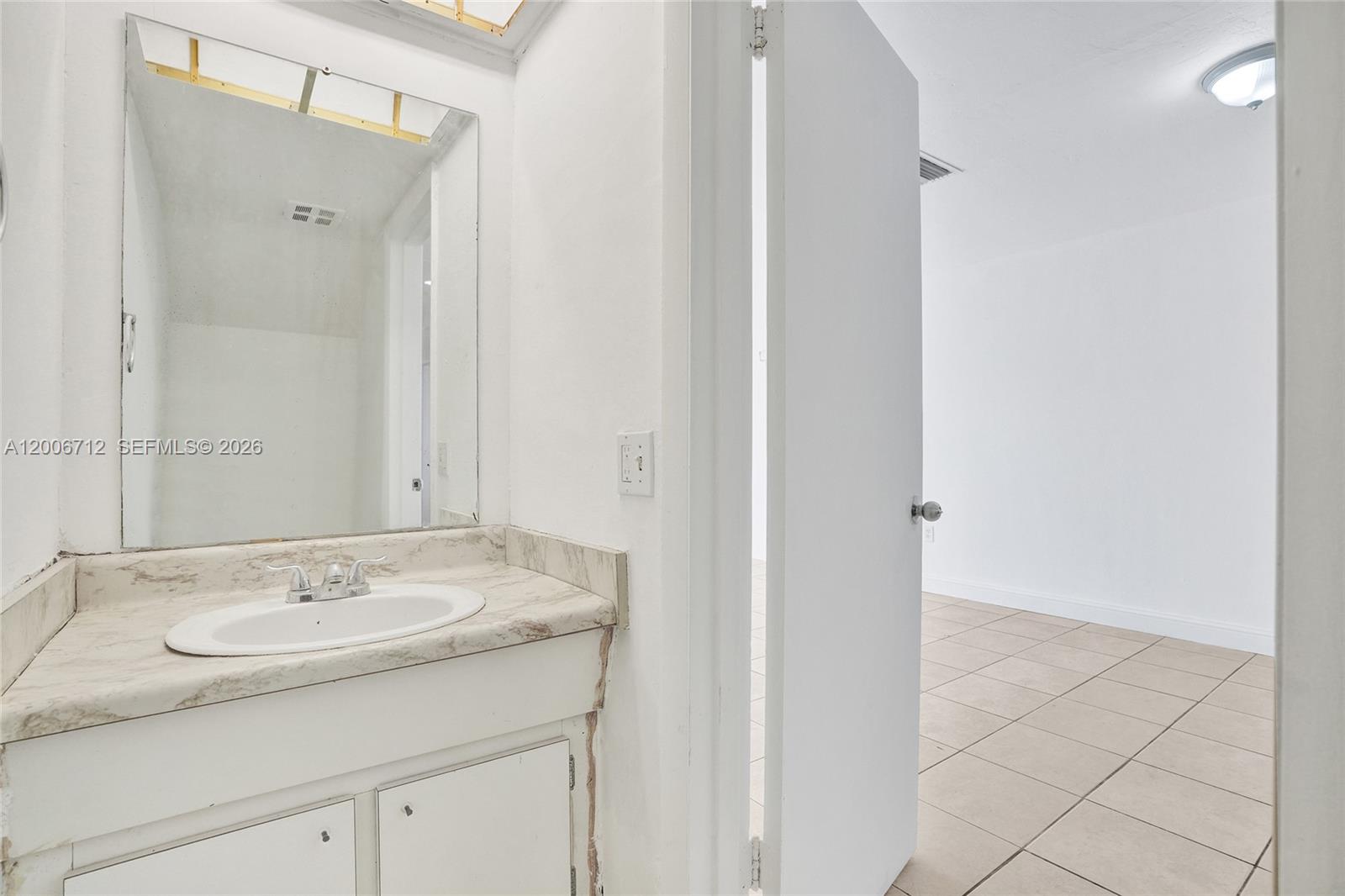 7344 Southwest 82nd Street, Unit C114 Miami, FL 33143 - Photo 13 of 30 a bathroom with a sink and a mirror