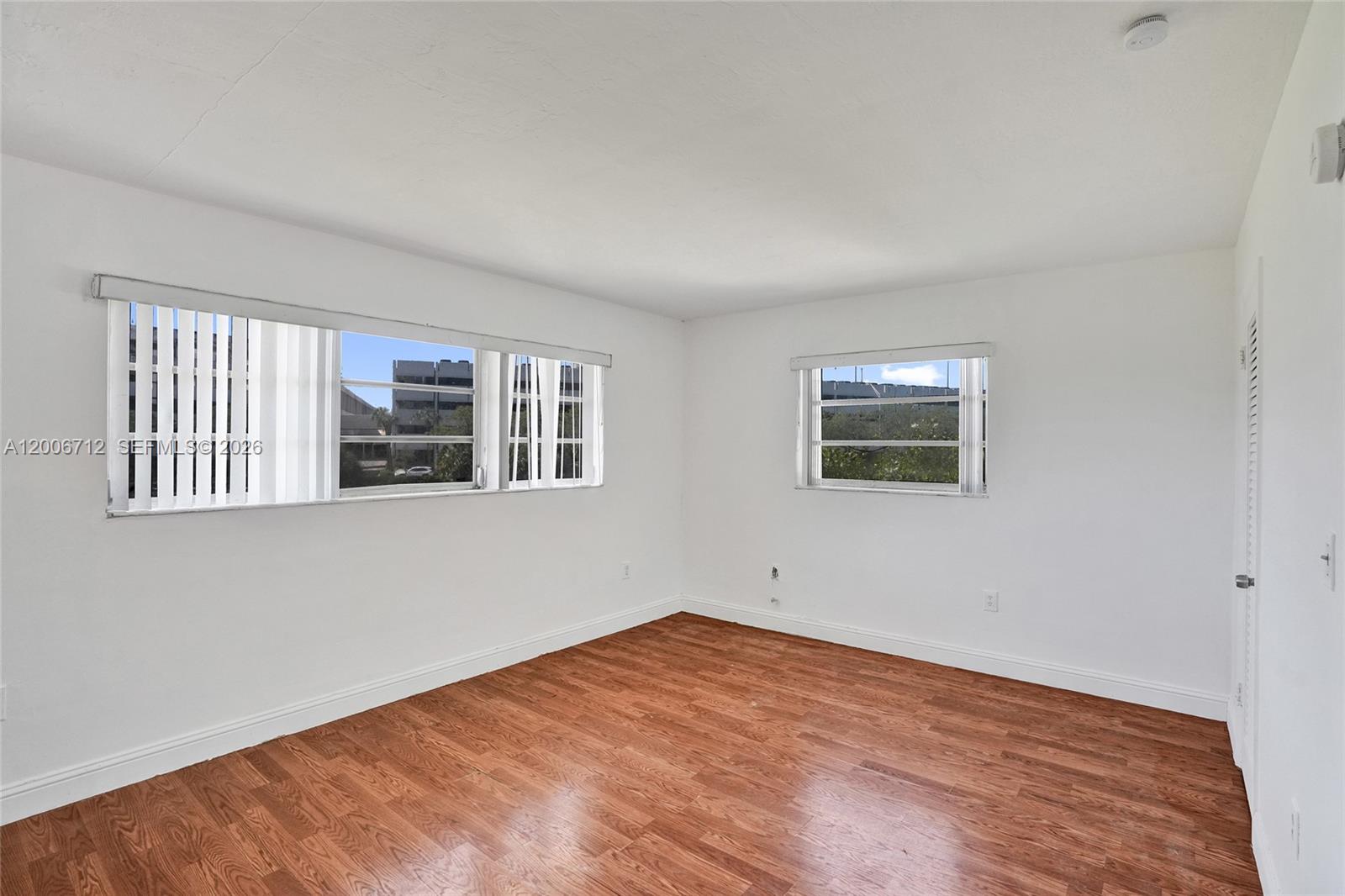 7344 Southwest 82nd Street, Unit C114 Miami, FL 33143 - Photo 14 of 30 a view of empty room with wooden floor and fan
