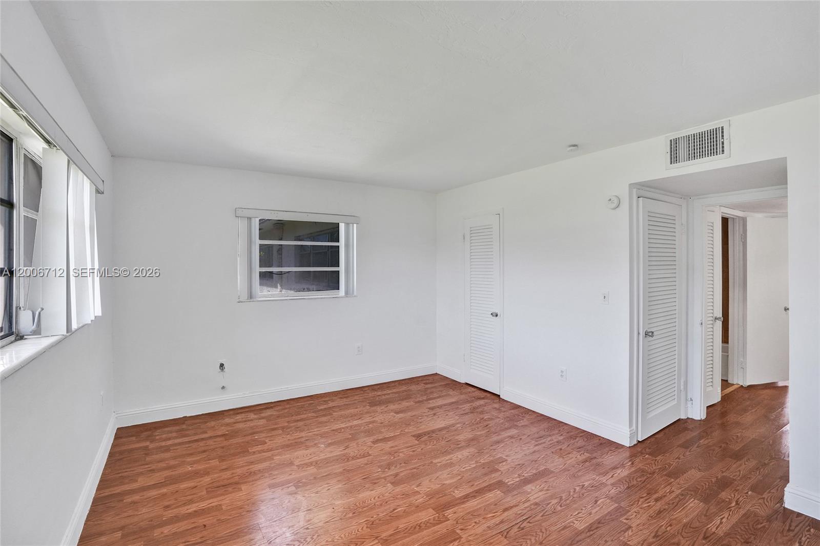 7344 Southwest 82nd Street, Unit C114 Miami, FL 33143 - Photo 15 of 30 a view of empty room with wooden floor and fan