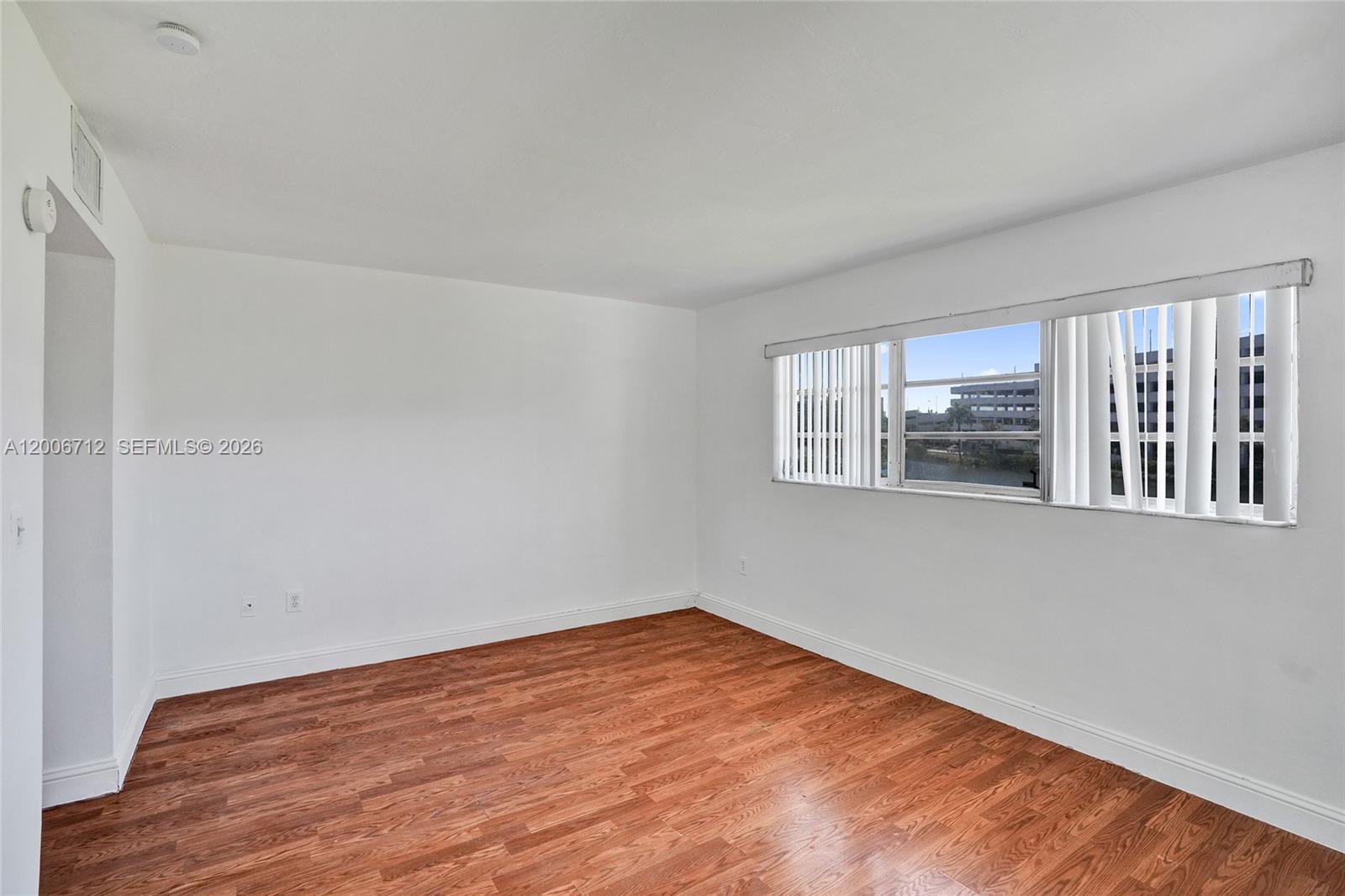 7344 Southwest 82nd Street, Unit C114 Miami, FL 33143 - Photo 16 of 30 a view of empty room with wooden floor and fan