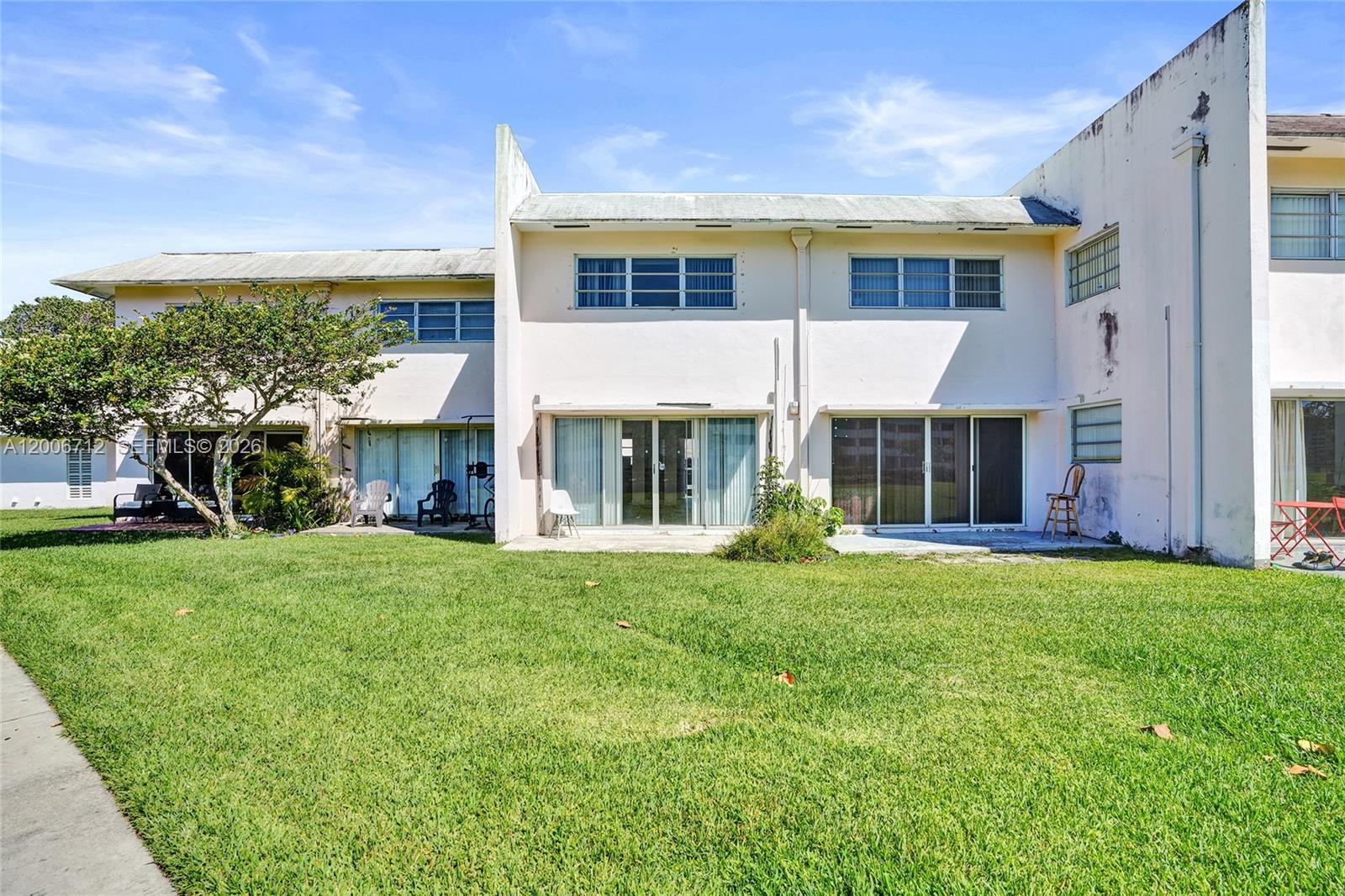 7344 Southwest 82nd Street, Unit C114 Miami, FL 33143 - Photo 28 of 30 a front view of a house with a yard