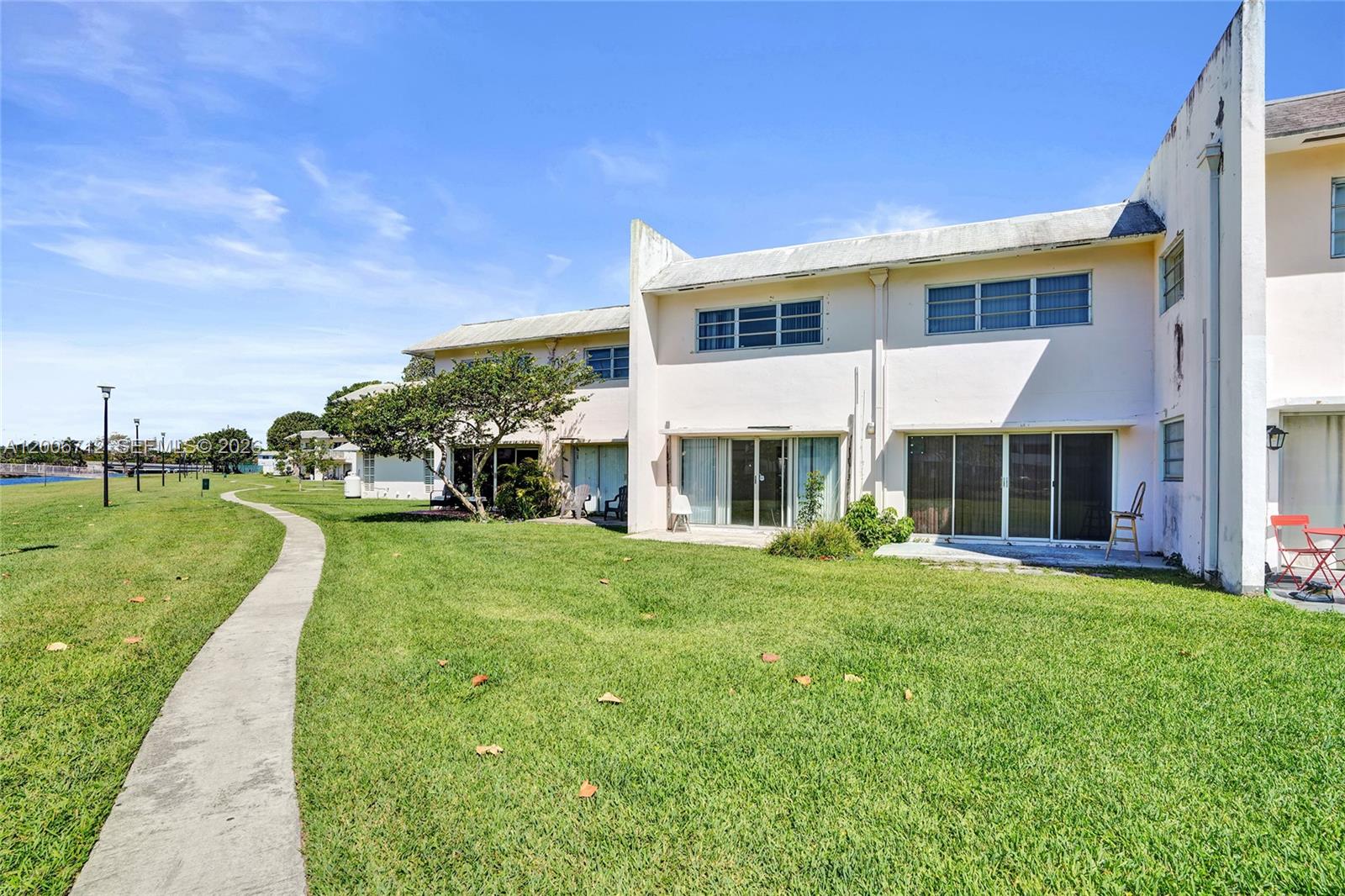 7344 Southwest 82nd Street, Unit C114 Miami, FL 33143 - Photo 29 of 30 a view of a house with a yard