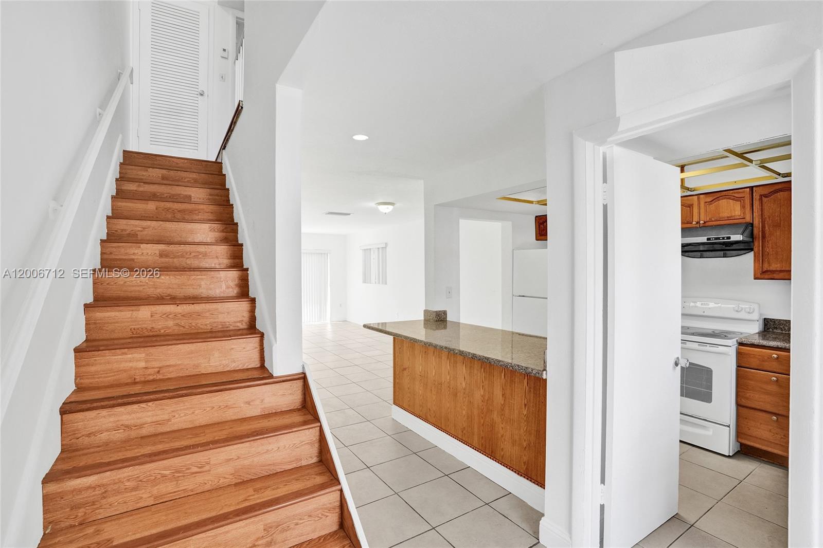7344 Southwest 82nd Street, Unit C114 Miami, FL 33143 - Photo 3 of 30 a view of an entryway with wooden floor and a fire place