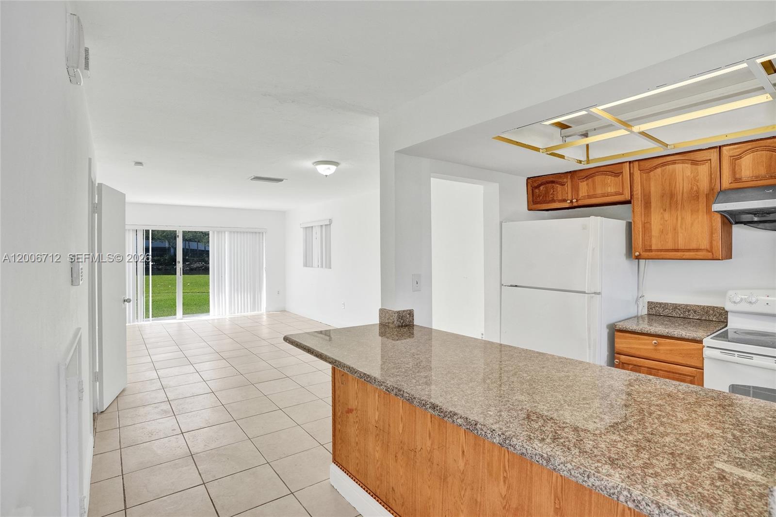7344 Southwest 82nd Street, Unit C114 Miami, FL 33143 - Photo 4 of 30 a kitchen with granite countertop a sink and a stove