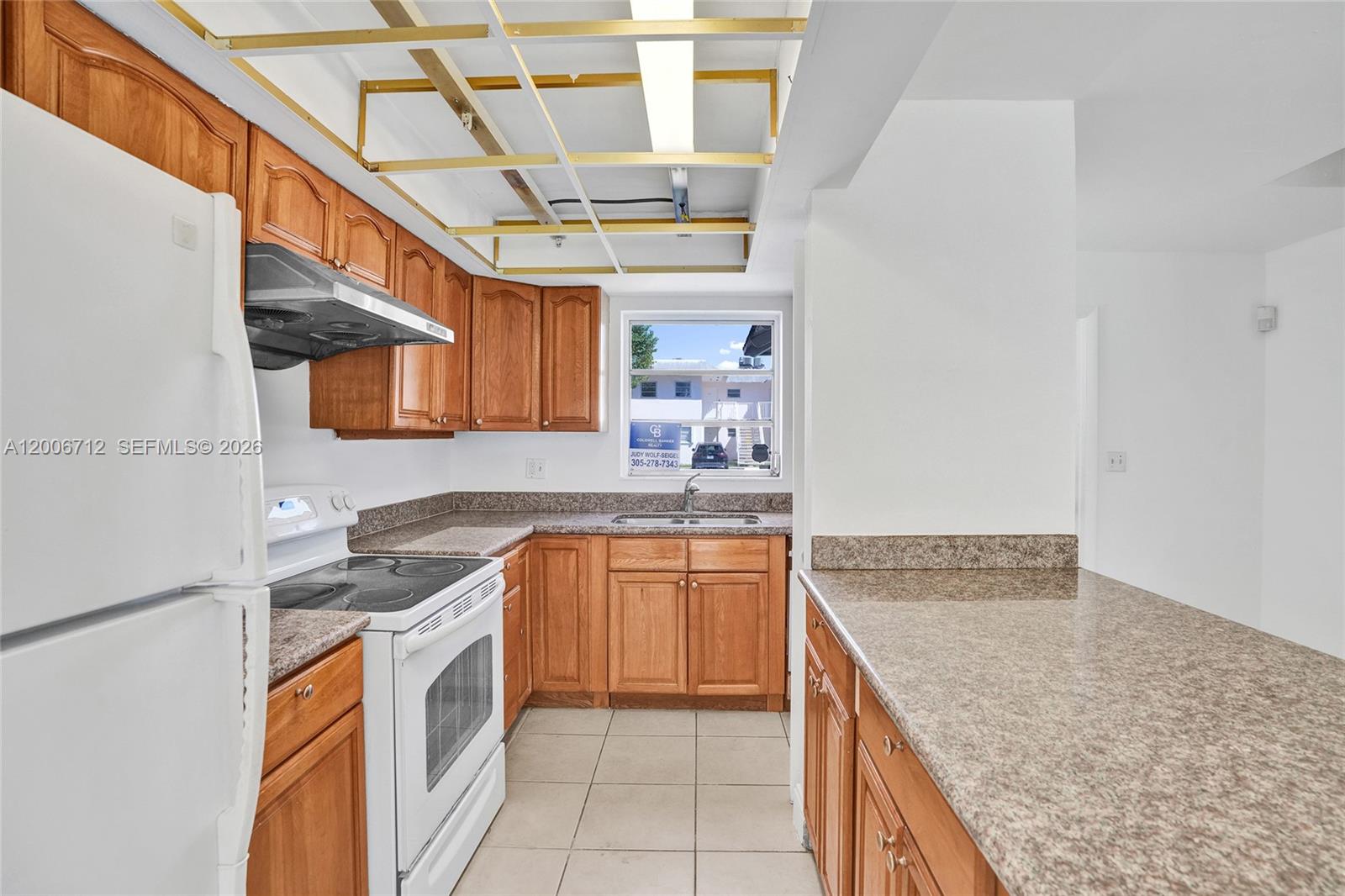 7344 Southwest 82nd Street, Unit C114 Miami, FL 33143 - Photo 7 of 30 a kitchen with stainless steel appliances granite countertop a sink stove and cabinets