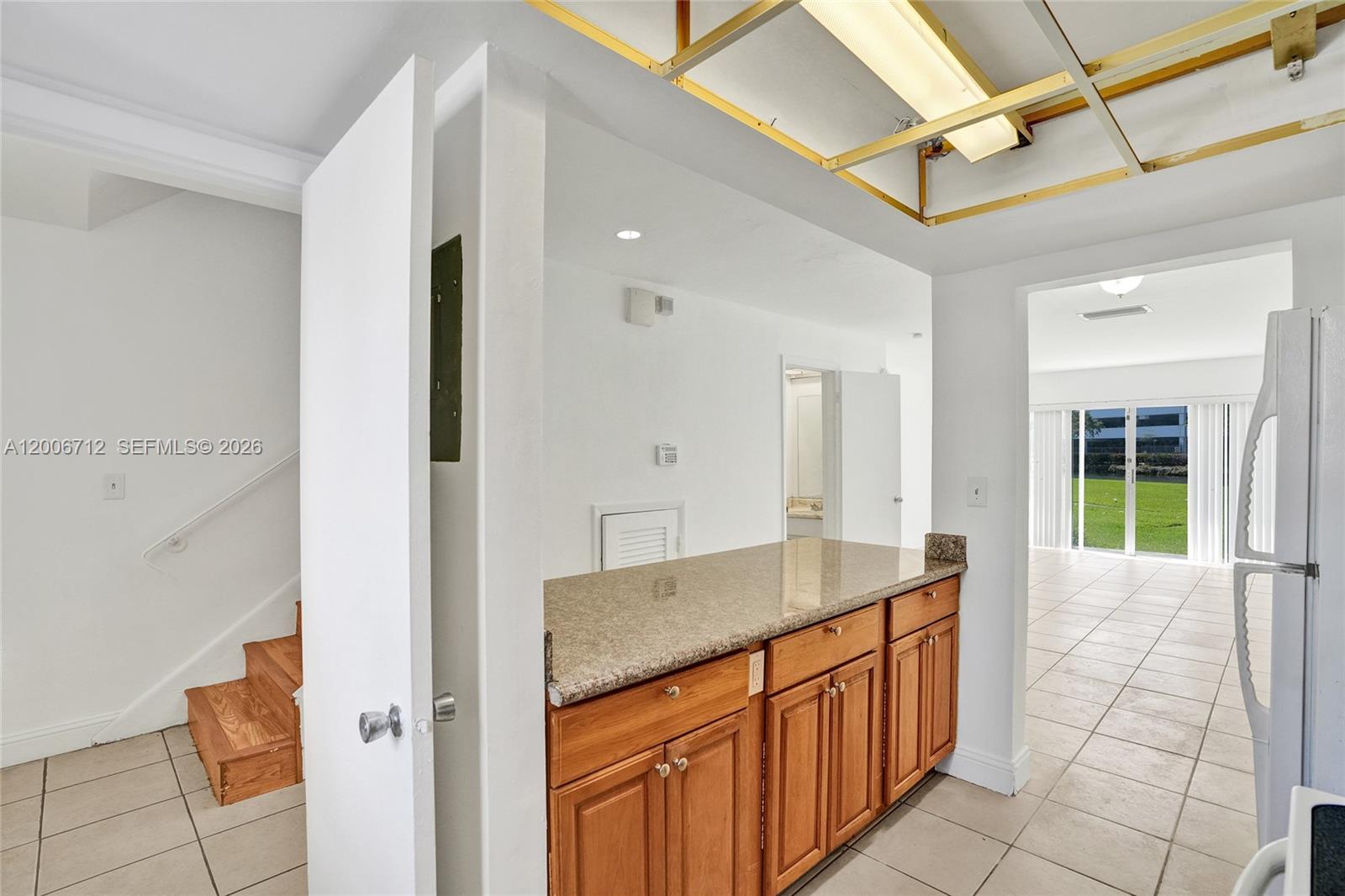7344 Southwest 82nd Street, Unit C114 Miami, FL 33143 - Photo 8 of 30 a bathroom with a granite countertop sink a mirror and a shower