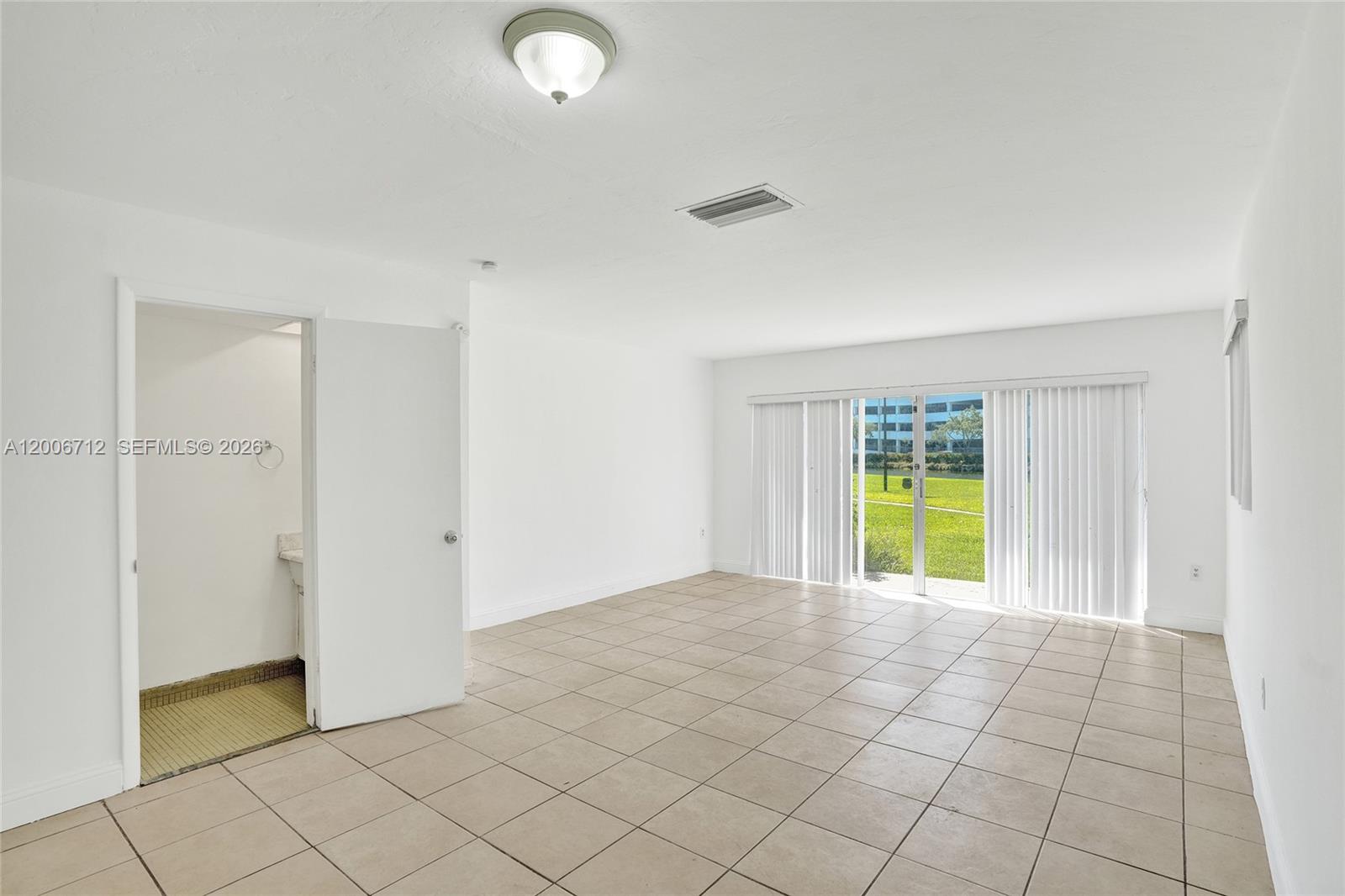 7344 Southwest 82nd Street, Unit C114 Miami, FL 33143 - Photo 9 of 30 a view of an empty room and window