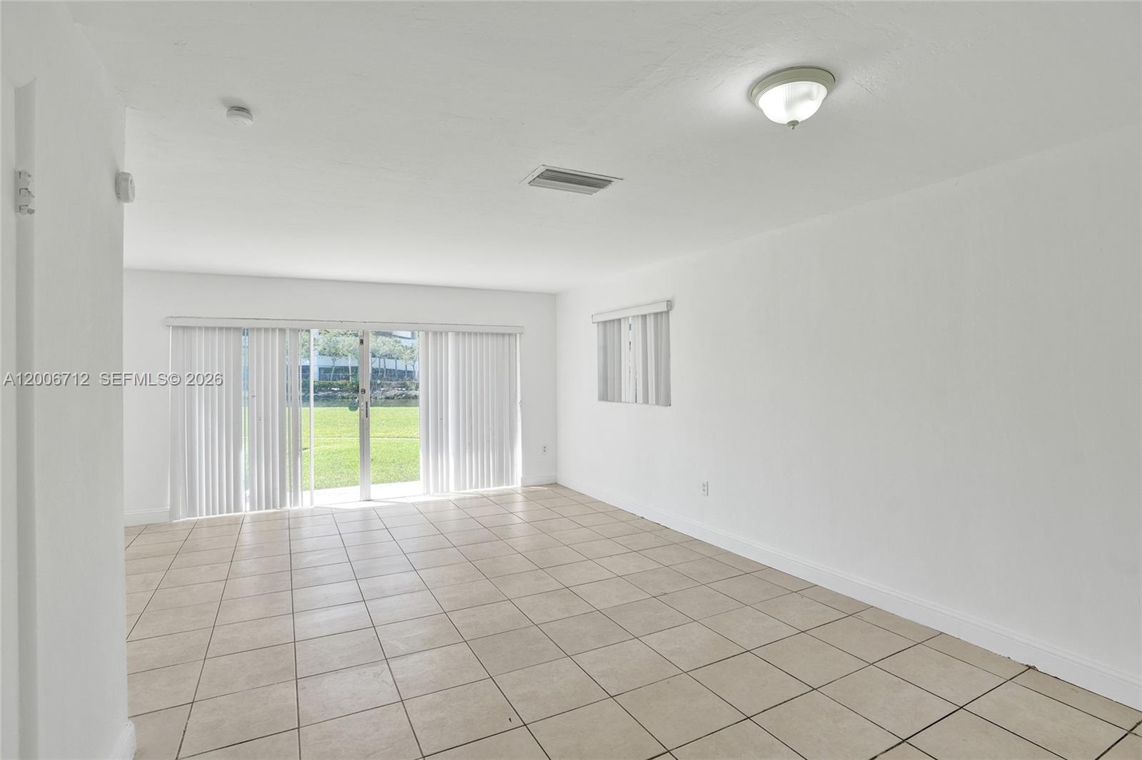 7344 Southwest 82nd Street, Unit C114 Miami, FL 33143 - Photo 10 of 30 a view of an empty room and window