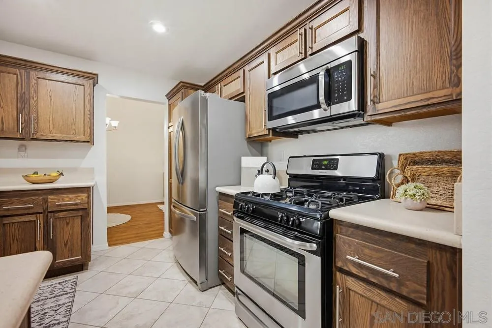 39900 Quigley Road Murrieta, CA 92562 - Photo 12 of 58 a kitchen with stainless steel appliances granite countertop a stove microwave and refrigerator