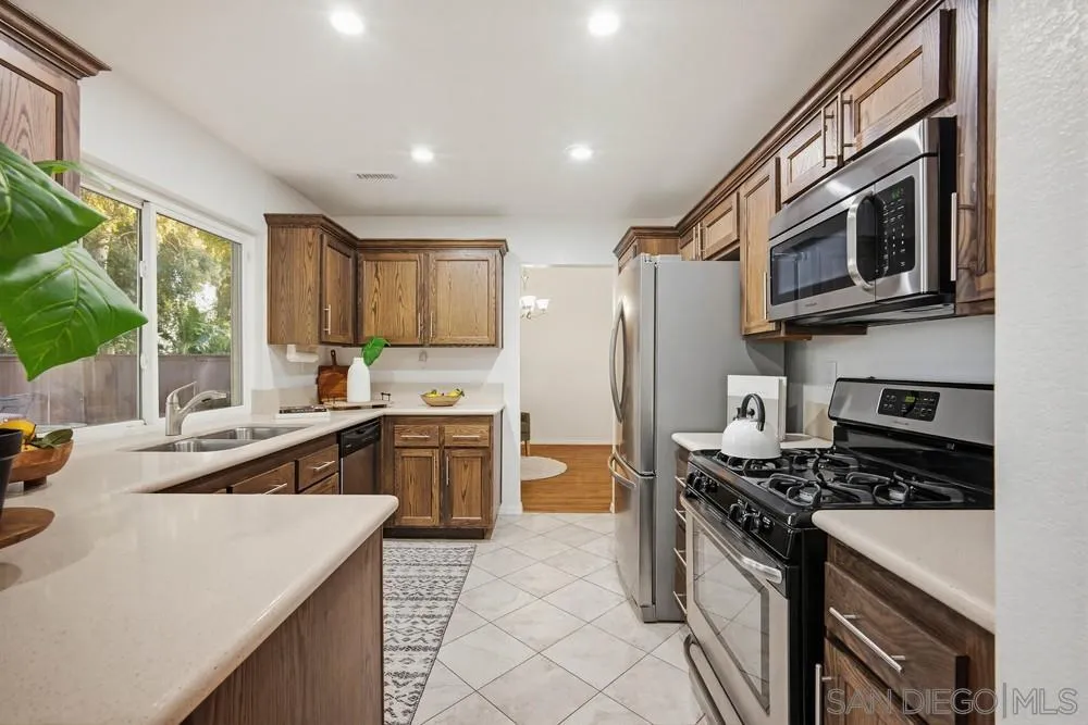 39900 Quigley Road Murrieta, CA 92562 - Photo 15 of 58 a kitchen with stainless steel appliances a stove a sink and a microwave