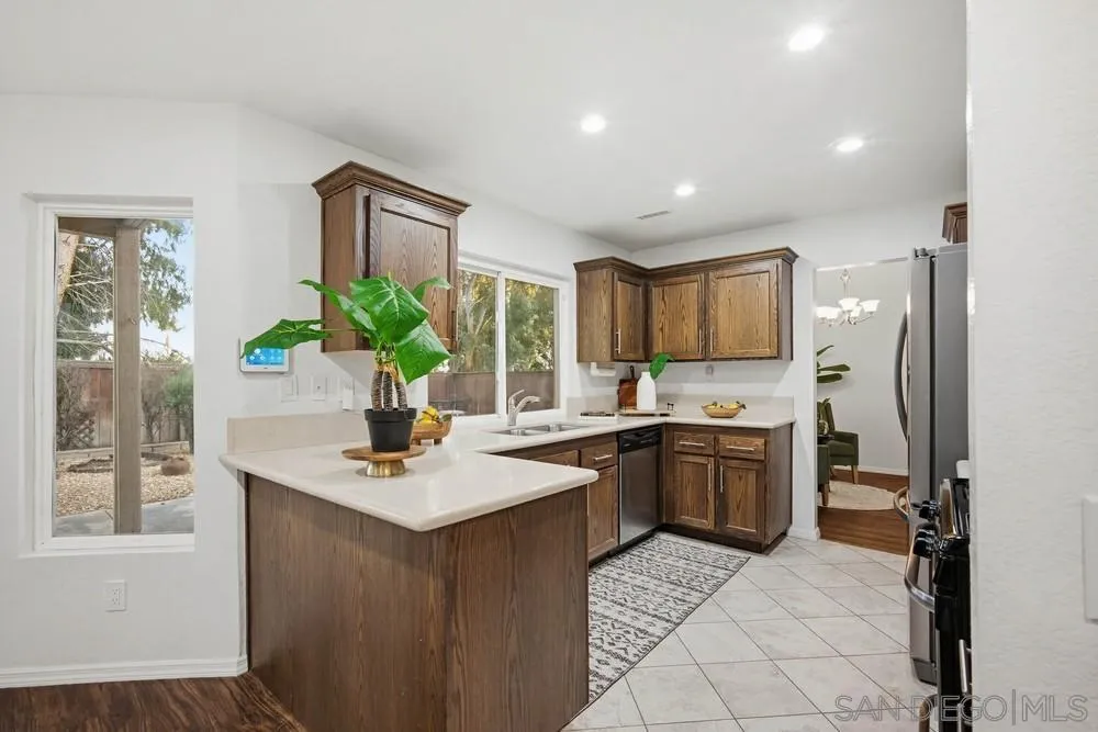 39900 Quigley Road Murrieta, CA 92562 - Photo 16 of 58 a kitchen with a sink refrigerator and microwave