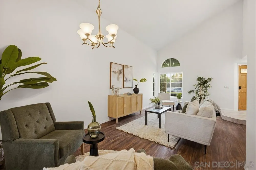 39900 Quigley Road Murrieta, CA 92562 - Photo 24 of 58 a living room with couches a coffee table and a chandelier with wooden floor