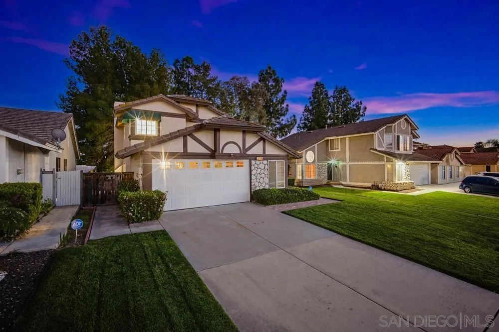 39900 Quigley Road Murrieta, CA 92562 - Photo 3 of 58 a front view of a house with a yard and garage