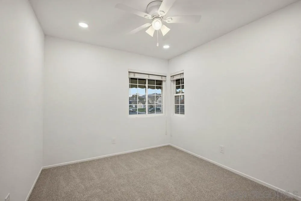 39900 Quigley Road Murrieta, CA 92562 - Photo 51 of 58 en empty room with windows and ceiling fan